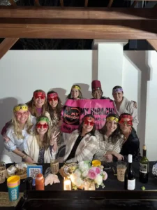 Bachelorette group posing with private hibachi chef and My Hibachi 30A banner in Alys Beach