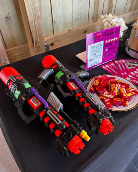 Water guns and candy setup for fun hibachi games at MyHibachiAtHome party station.
