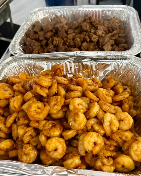 Grilled shrimp and steak trays prepared for MyHibachiAtHome buffet catering event.