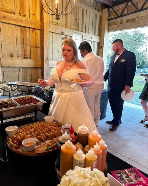 Bride enjoying hibachi buffet with appetizers and sauces at MyHibachiAtHome wedding event