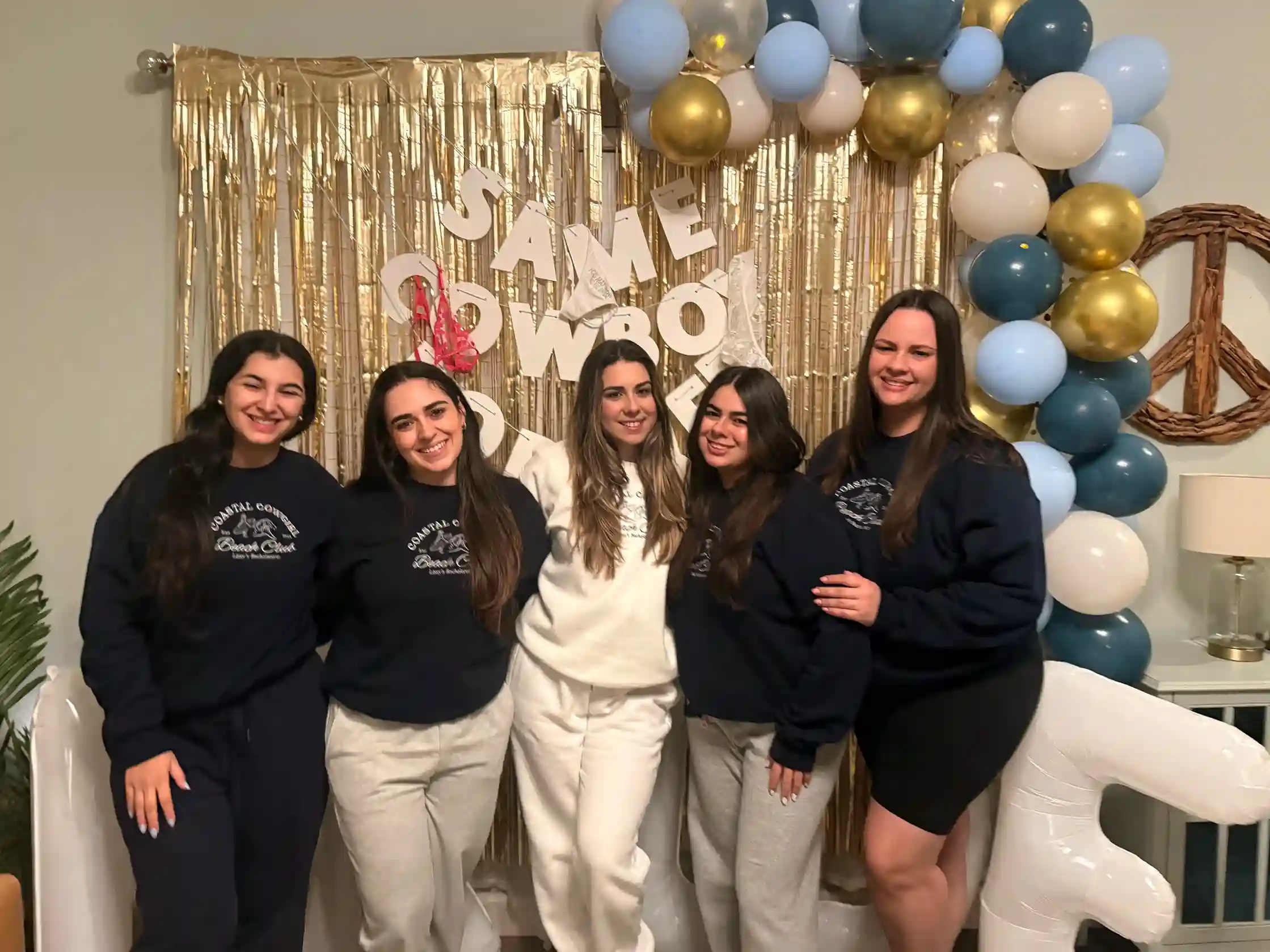 Group of women celebrating a pajama-themed bachelorette party in Inlet Beach with balloons and decor