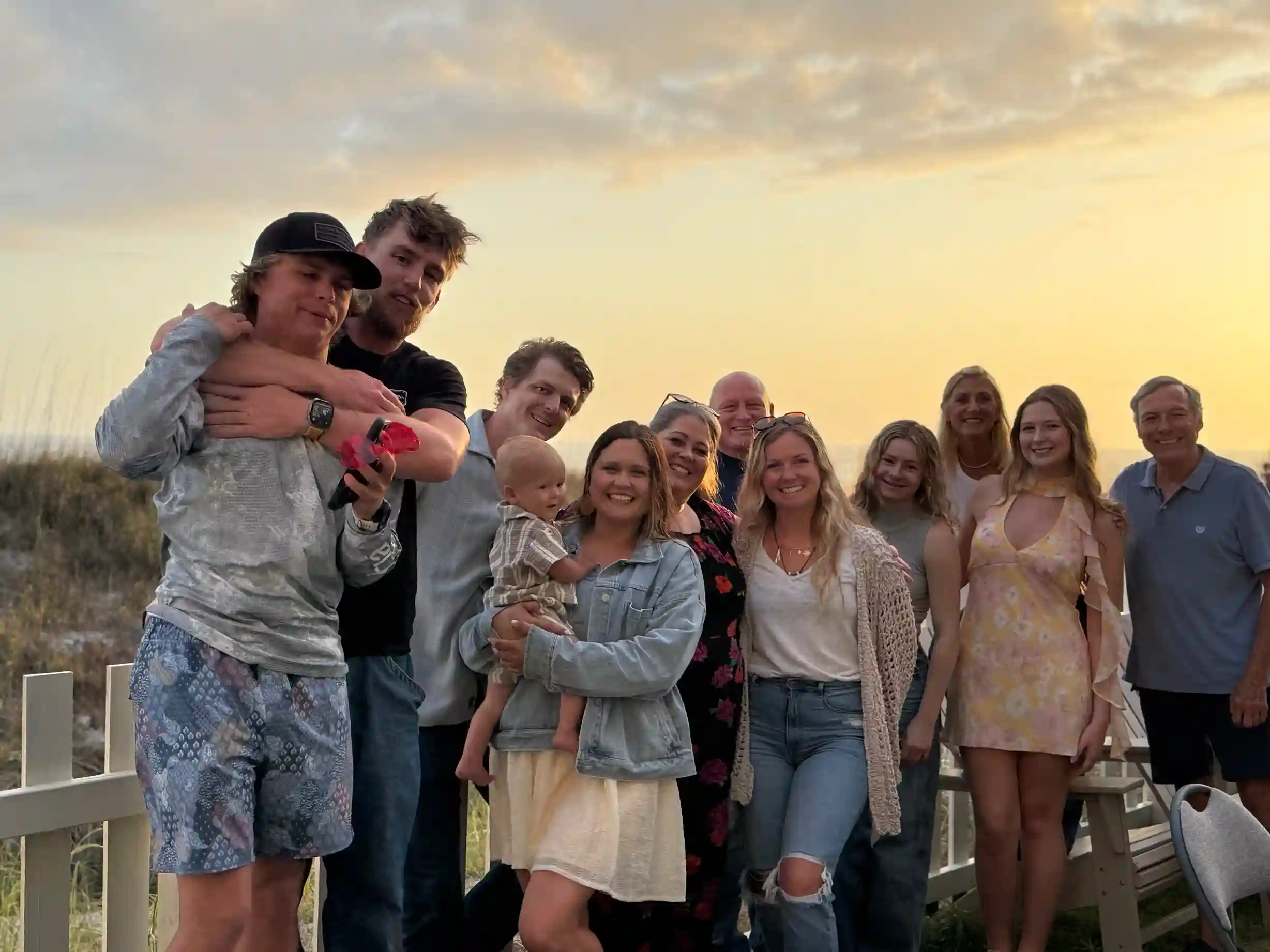 Family group smiling during sunset at a hibachi dinner in Kiska Beach, Florida.