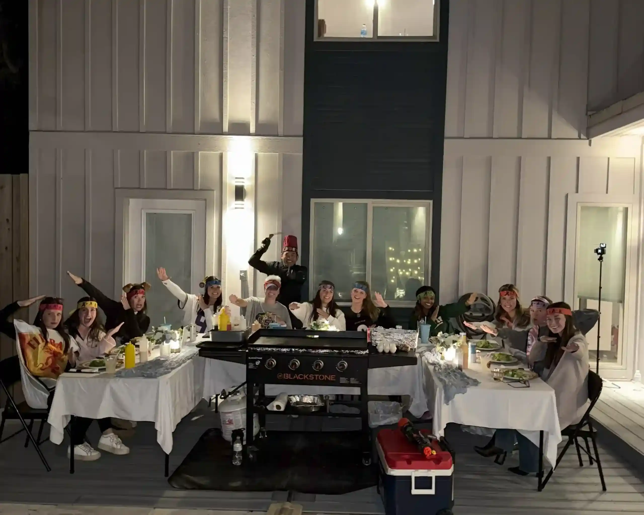 Group enjoying private hibachi dinner at a 30A vacation rental with chef and custom table setup