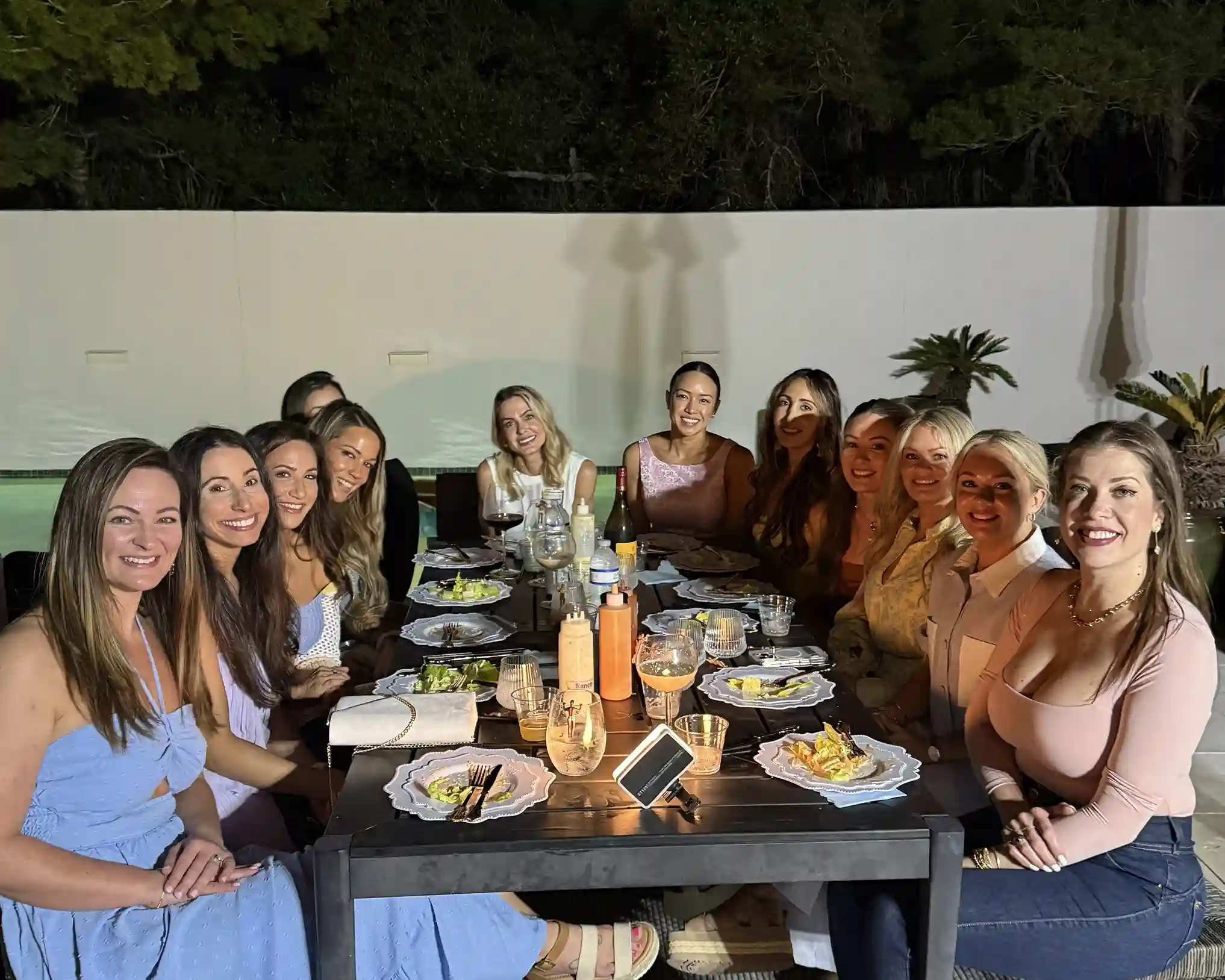 Group of women enjoying a private hibachi dinner party in Panama City Beach at night
