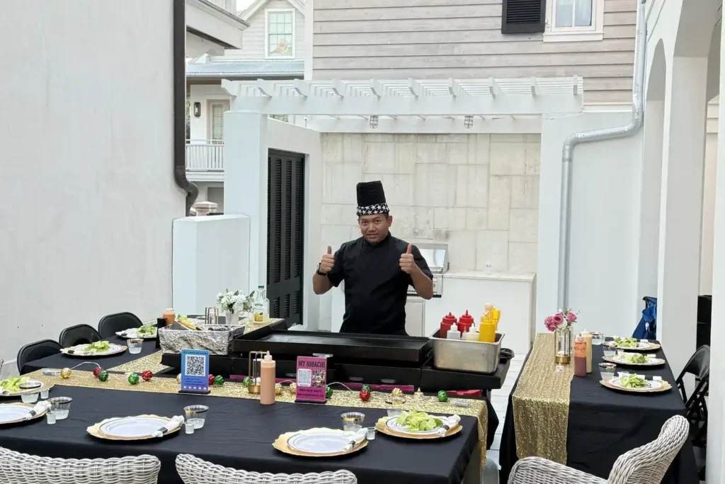 Private hibachi chef giving thumbs up before dinner setup in Alys Beach patio