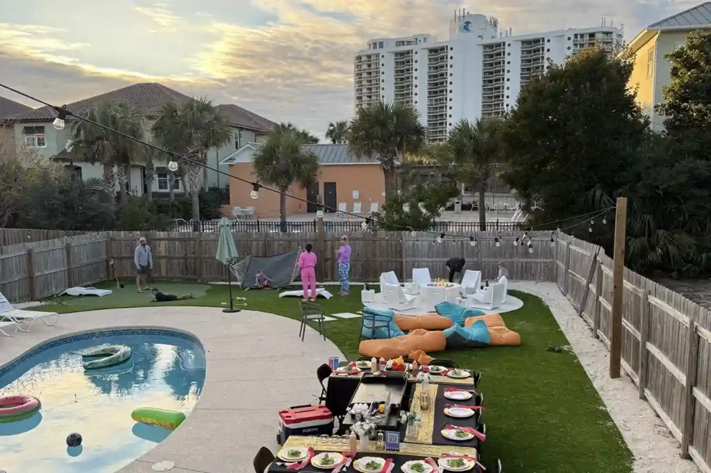 Backyard setup for private hibachi party near pool with tables and bean bags